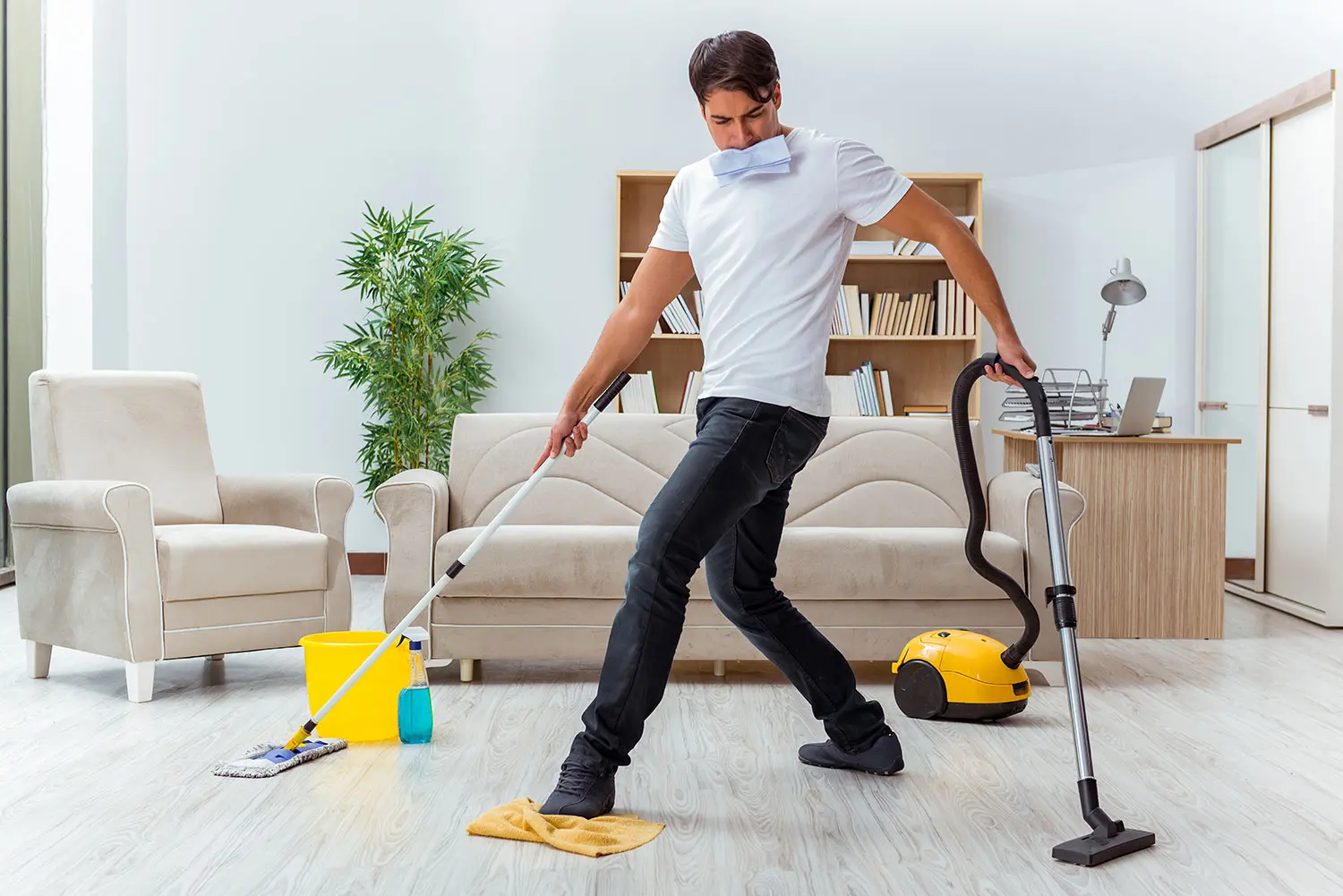 Man vacuuming the floor image.